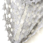 Silvery-white Frostyflakes Wrap, tied, photographed with light filled blurred framing