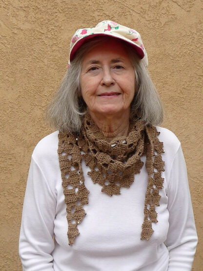 "Morning-Glo" proudly models her tan scarf-size Frostyflakes, tastefully accented with faceted beads.
