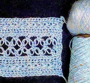 Double-stranded Lovelace swatch: sport weight Lotus and lace weight glittery mohair.