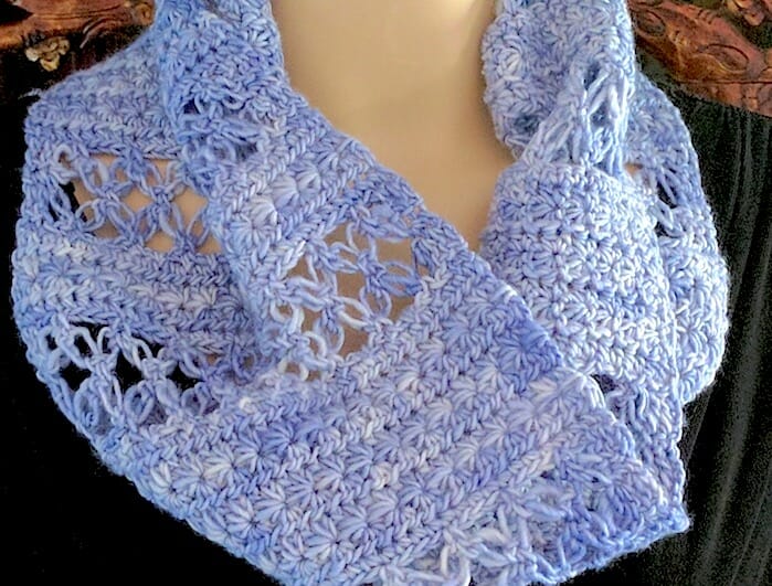 Close up of Lovelace Ring Scarf: bands of love knot mesh alternate with star stitch bands.