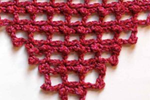 Picot filet stitch pattern started in the corner and increased at each row end using stitch equivalents.