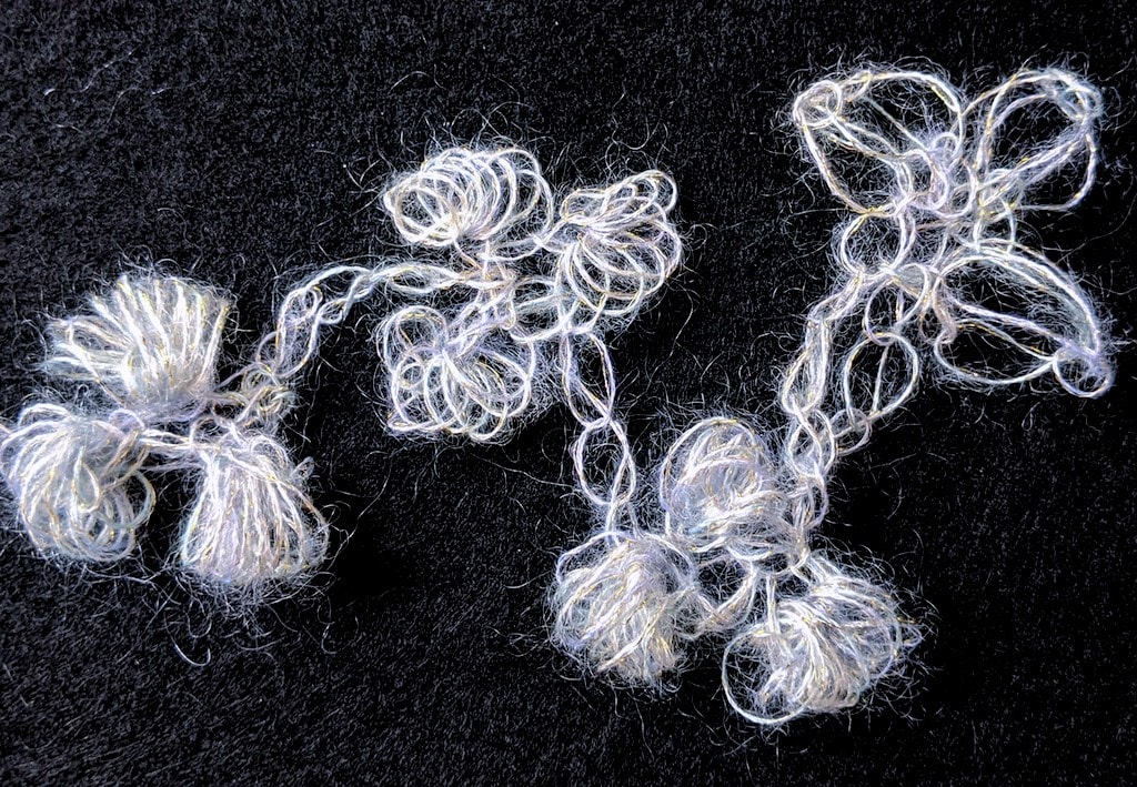 Four bobble clusters in mohair: half-double puff, limpets, clones knots, love knot pods.