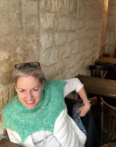 Vashti wears her crocheted angora "Orbit Halo" cowl in a stone-walled breakfast cafe in the old part of Paris