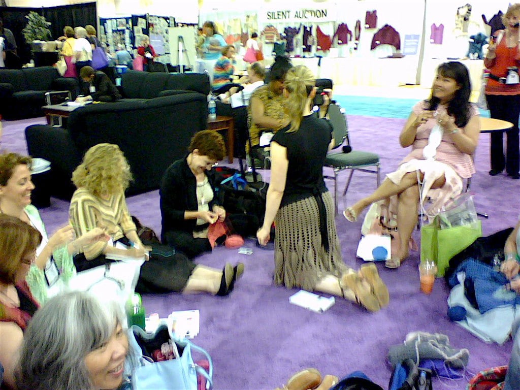 Amy O'Neill Houck's photo of Brett Bara podcasting while crochet designers protest last of crochet representation 60s-style at 2007 TNNA industry show