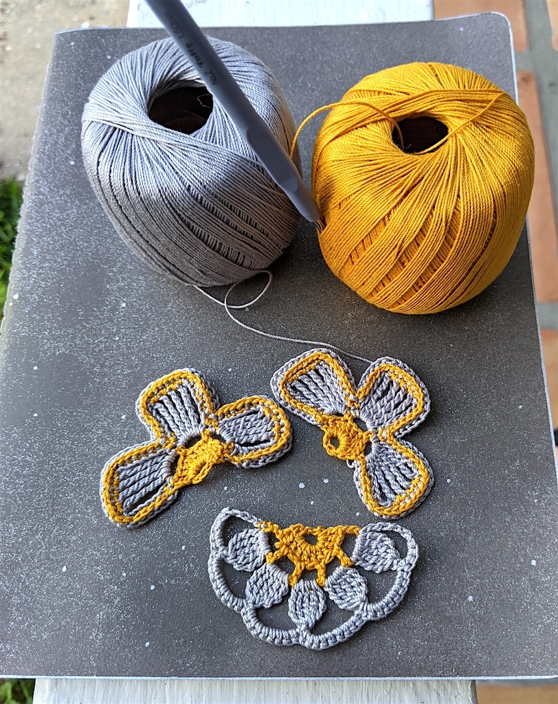 The 3 half-flowers in pewter and antique gold colors before sewing Molestine crochet notebook seam